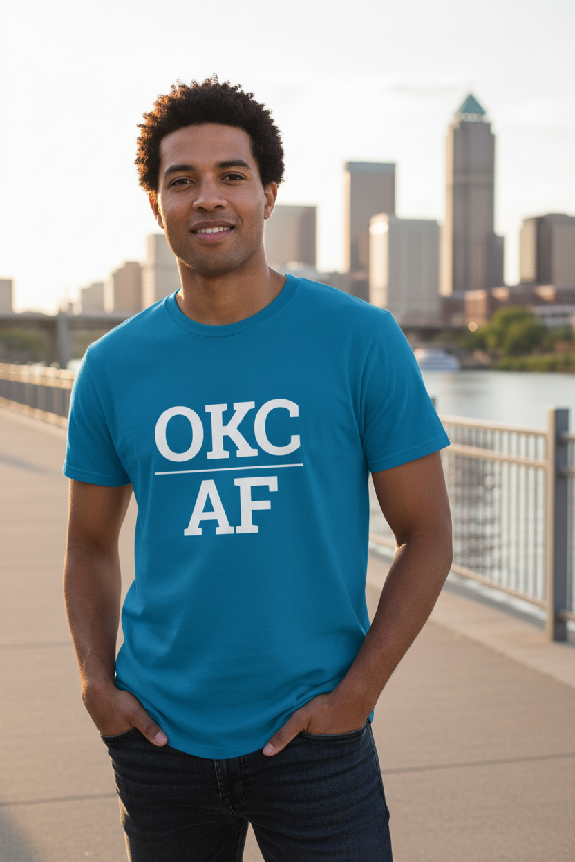 Mixed-race man wearing sapphire OKC_AF t-shirt at Oklahoma River waterfront