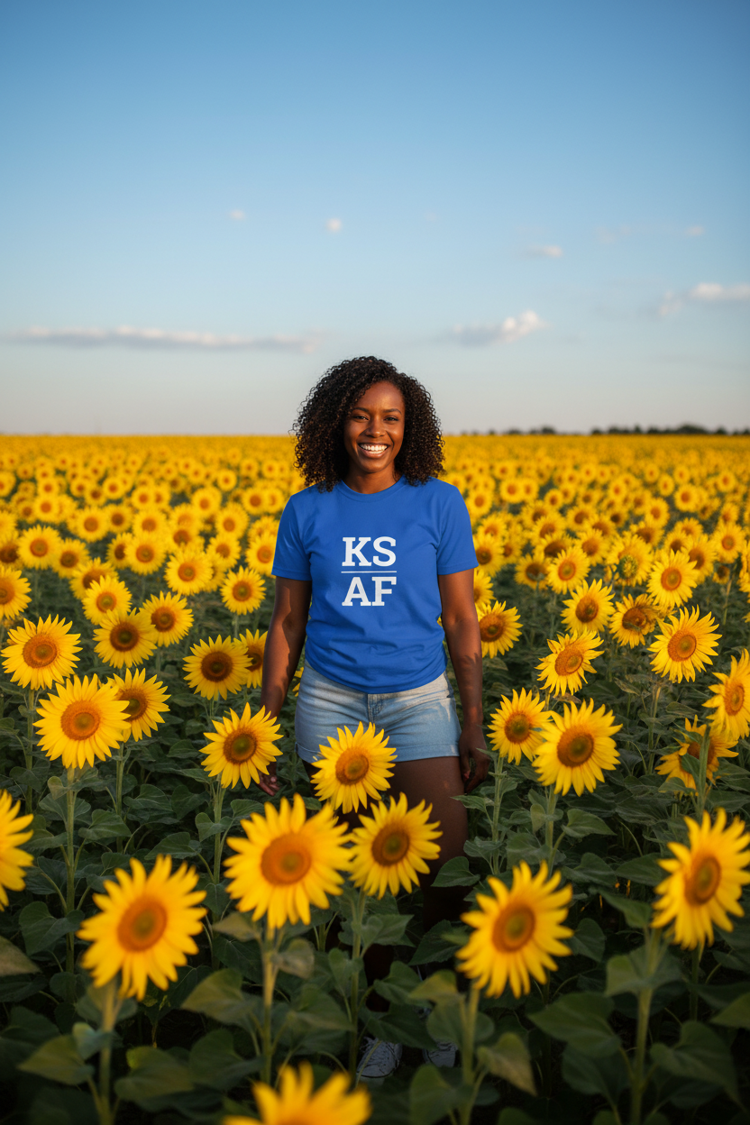 Person wearing blue Kansas t-shirt in a sunflower field